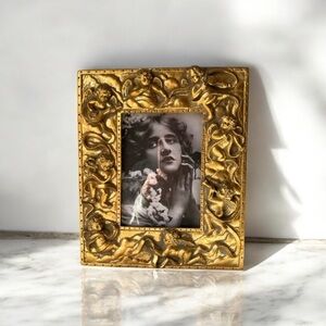 Large gilded Cherub Picture Frame holds 5”x7”. Rare